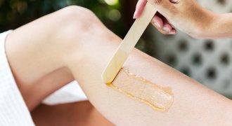 beauty specialist applying wax to womans leg | hair removal wax